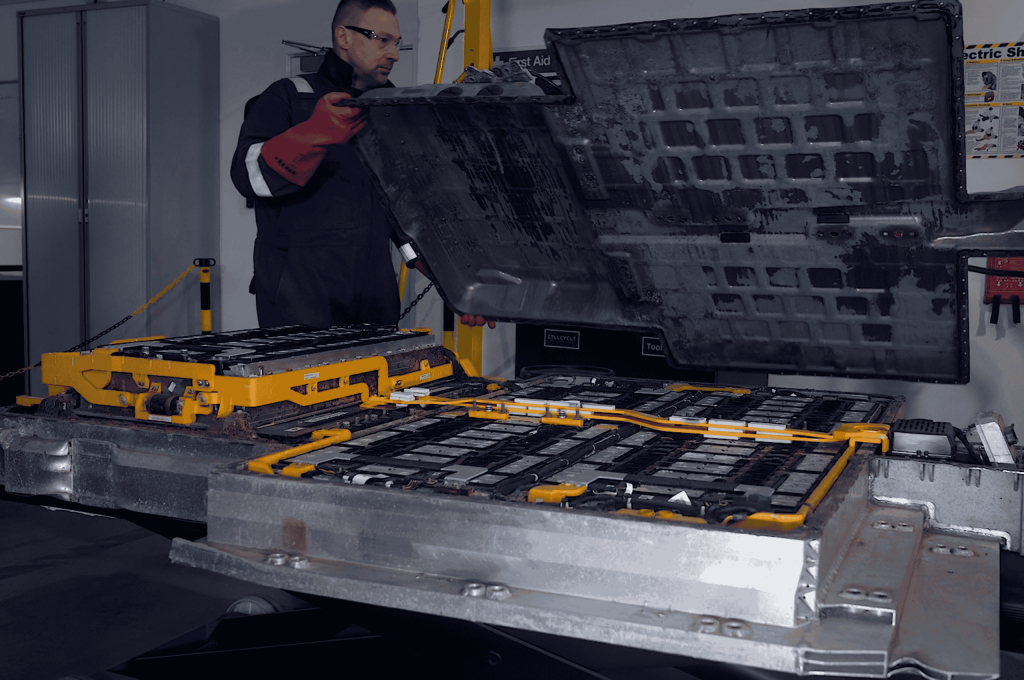 Cellcycle staff removing the cover from ev battery pack