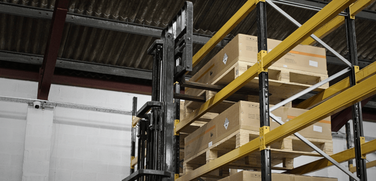 forklift uploading battery packs into the rack