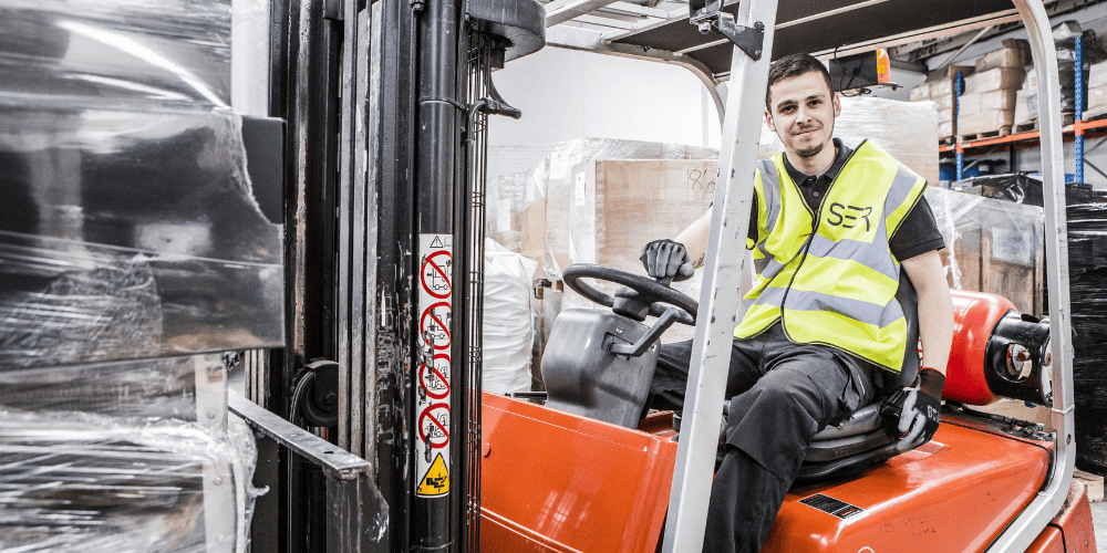 Cellcycle staff working on the forklift